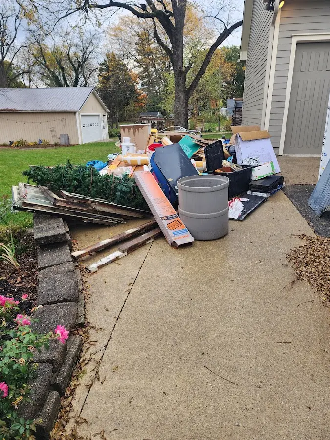 Dumpster being loaded with debris for 12 Yard Dumpster Rental in Drexel Heights